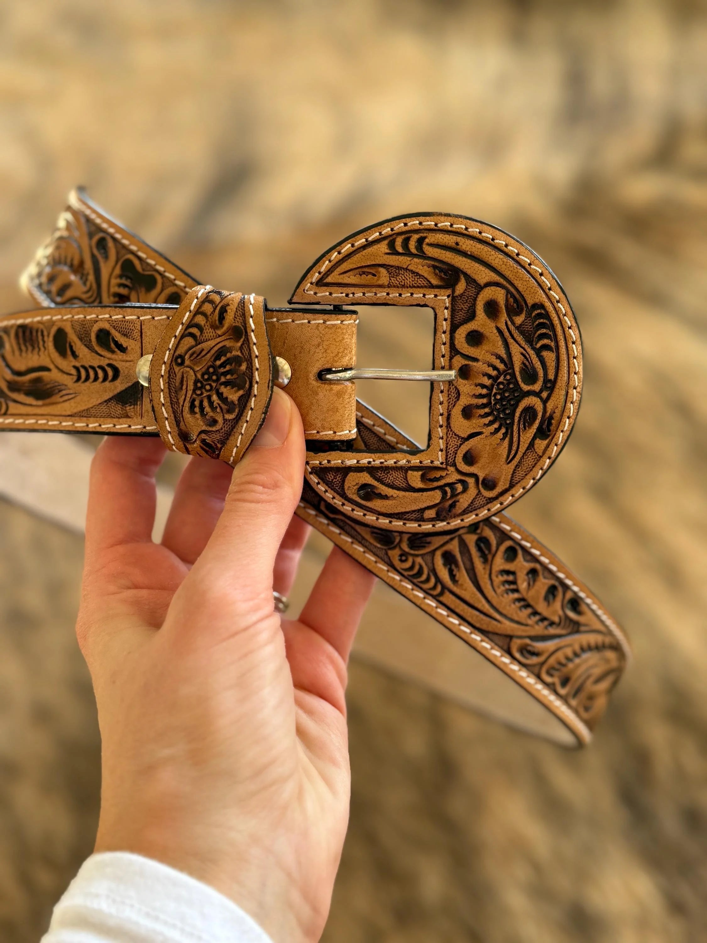 Round buckle tooled leather belt